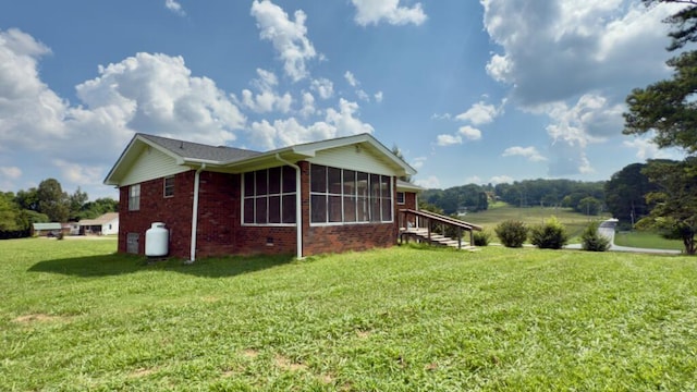 51 Poppy Ln, Ringgold, GA 30736 - view of side of home featuring a sunroom, brick siding, and a yard