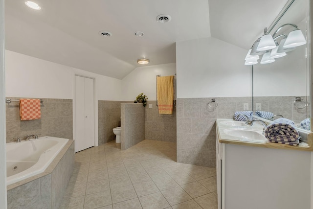 301 Brandywine Dr, Old Hickory, TN 37138 - bathroom with vaulted ceiling, a whirlpool tub, tile walls, tile patterned flooring, and double vanity