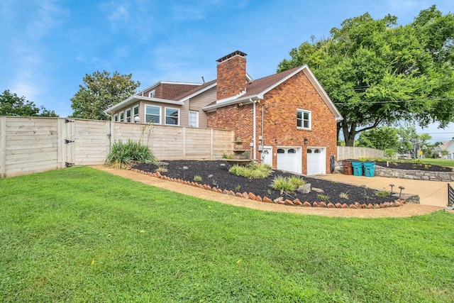 301 Brandywine Dr, Old Hickory, TN 37138 - view of home's exterior with a chimney, an attached garage, brick siding, a gate, and concrete driveway