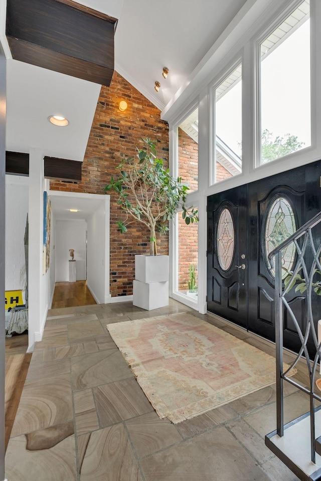 301 Brandywine Dr, Old Hickory, TN 37138 - foyer entrance featuring brick wall, stone tile floors, high vaulted ceiling, and plenty of natural light