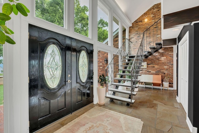 301 Brandywine Dr, Old Hickory, TN 37138 - foyer with brick wall, stairway, high vaulted ceiling, and stone tile flooring