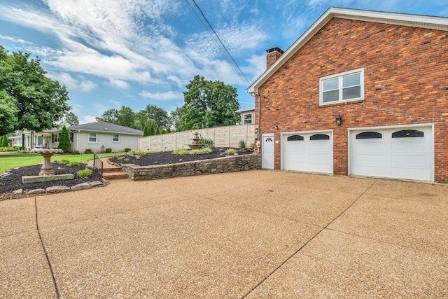 301 Brandywine Dr, Old Hickory, TN 37138 - view of property exterior featuring a chimney, brick siding, concrete driveway, and a garage