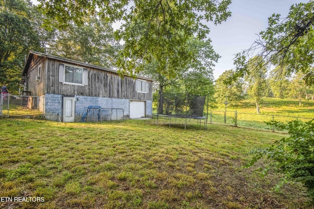 197 Wedgewood Ln, Spring City, TN 37381 - fenced backyard featuring a trampoline and a garage