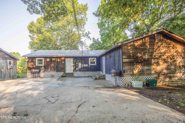 197 Wedgewood Ln, Spring City, TN 37381 - back of property featuring entry steps, a metal roof, and a patio