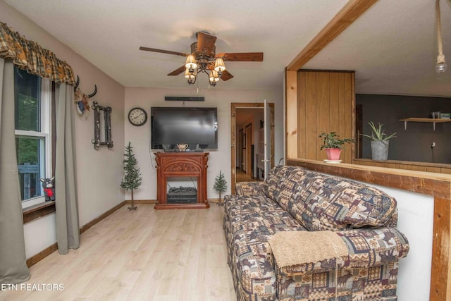 197 Wedgewood Ln, Spring City, TN 37381 - living room with ceiling fan, light wood finished floors, and a fireplace with raised hearth