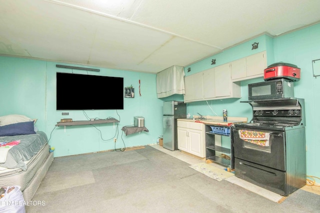 197 Wedgewood Ln, Spring City, TN 37381 - kitchen featuring black appliances, light carpet, open floor plan, and light countertops