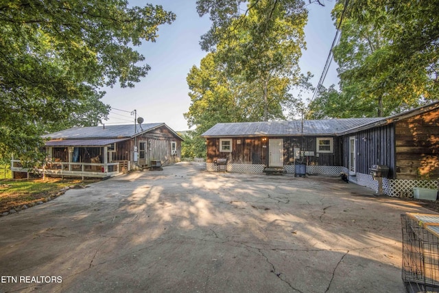197 Wedgewood Ln, Spring City, TN 37381 - rear view of property featuring concrete driveway and a metal roof
