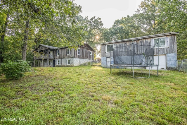 197 Wedgewood Ln, Spring City, TN 37381 - view of green lawn with a trampoline and a wooden deck