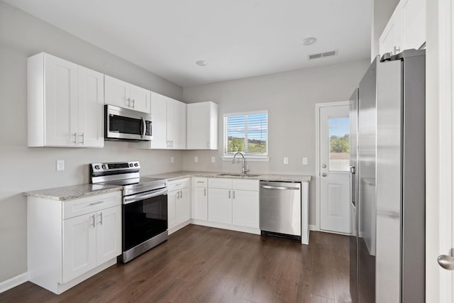 241 Tara Ct, Columbia, TN 38401 - kitchen with stainless steel appliances, dark wood-type flooring, white cabinets, and light stone counters