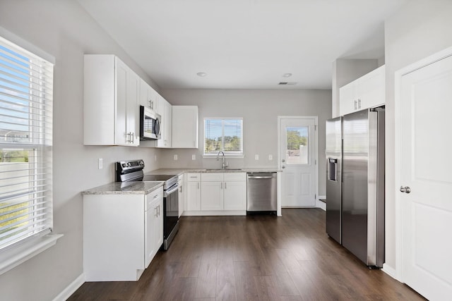 241 Tara Ct, Columbia, TN 38401 - kitchen with stainless steel appliances, light stone counters, white cabinets, dark wood-style floors, and recessed lighting