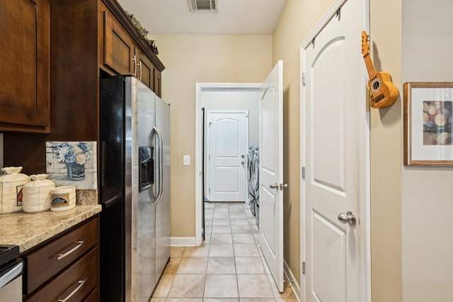 1609 Merritt St Unit A, Old Hickory, TN 37138 - kitchen featuring stainless steel fridge, dark brown cabinetry, and washing machine and dryer