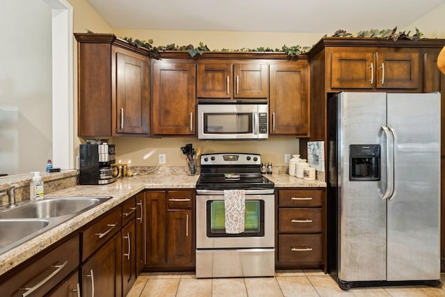 1609 Merritt St Unit A, Old Hickory, TN 37138 - kitchen with stainless steel appliances, light tile patterned floors, light stone countertops, and dark brown cabinetry