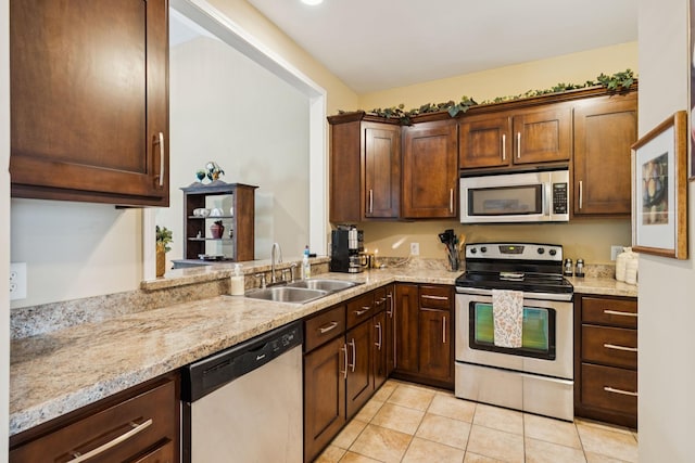 1609 Merritt St Unit A, Old Hickory, TN 37138 - kitchen with appliances with stainless steel finishes, light tile patterned flooring, light stone counters, and dark brown cabinetry