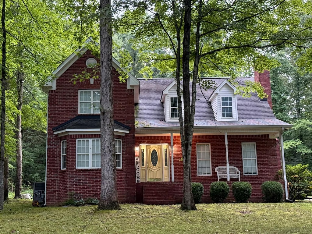 112 Hillwood Dr, Dickson, TN 37055 - view of front of property with a chimney, a front lawn, and brick siding