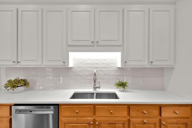 2785 Rutland Ct, Thompsons Station, TN 37179 - kitchen with stainless steel dishwasher, white cabinets, decorative backsplash, and light countertops