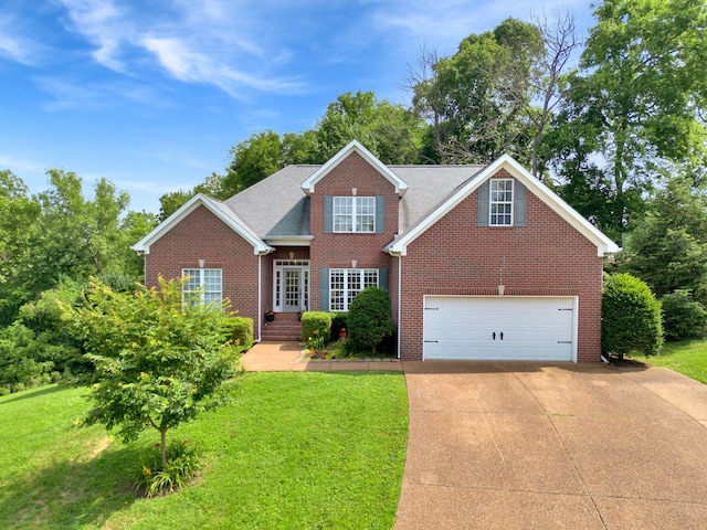 2785 Rutland Ct, Thompsons Station, TN 37179 - traditional-style home featuring brick siding, driveway, and a front lawn