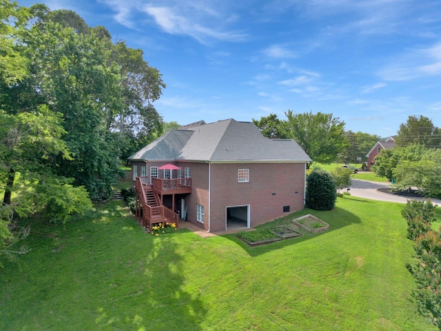 2785 Rutland Ct, Thompsons Station, TN 37179 - back of property with a deck, a garage, stairway, a yard, and brick siding