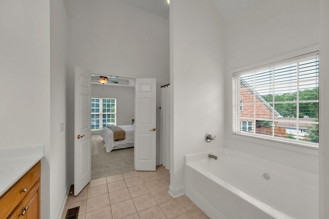 2785 Rutland Ct, Thompsons Station, TN 37179 - bathroom with vanity, a garden tub, a ceiling fan, tile patterned floors, and a towering ceiling
