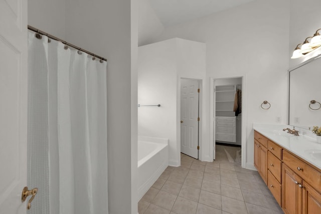 2785 Rutland Ct, Thompsons Station, TN 37179 - bathroom featuring tile patterned floors, double vanity, a garden tub, and a walk in closet