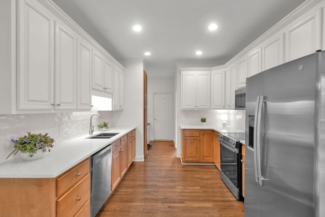 2785 Rutland Ct, Thompsons Station, TN 37179 - kitchen featuring appliances with stainless steel finishes, wood finished floors, decorative backsplash, recessed lighting, and white cabinets