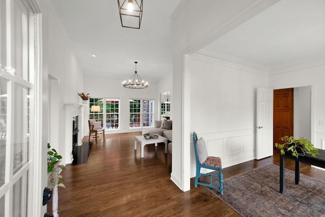 2785 Rutland Ct, Thompsons Station, TN 37179 - foyer entrance with dark wood finished floors, a chandelier, crown molding, a fireplace, and a wainscoted wall