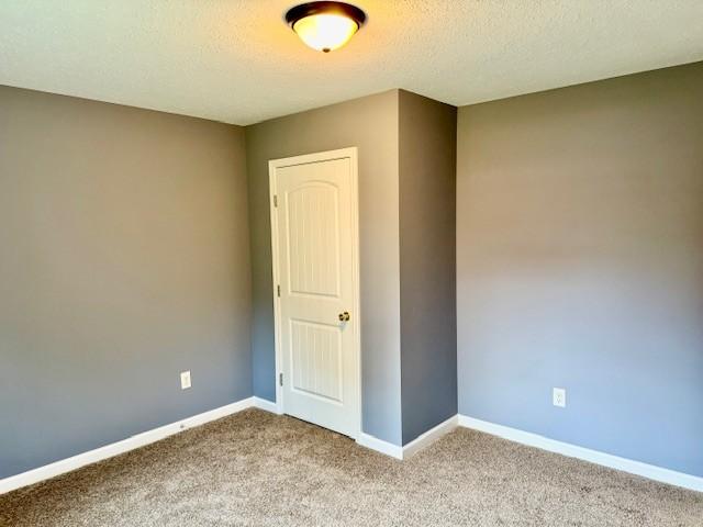 208 Broadrick St, Tullahoma, TN 37388 - unfurnished room featuring carpet and a textured ceiling