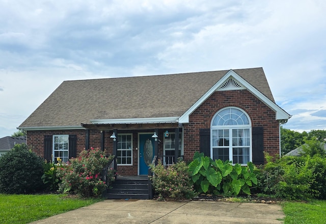 116 Chad St E, Portland, TN 37148 - view of front of house with brick siding, a shingled roof, and covered porch