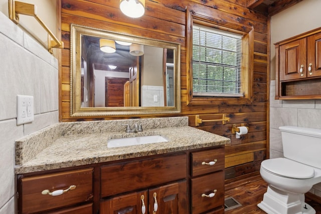 584 Mccord Hollow Rd, Hohenwald, TN 38462 - half bath with vanity, wooden walls, and wood finished floors