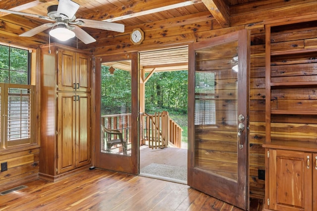 584 Mccord Hollow Rd, Hohenwald, TN 38462 - doorway featuring wood walls, light wood-style floors, a wooden ceiling with exposed beams, and a ceiling fan