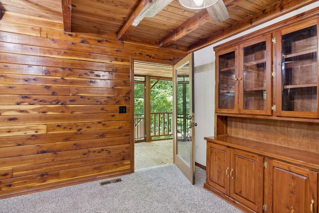 584 Mccord Hollow Rd, Hohenwald, TN 38462 - interior space with a wood ceiling with exposed beams, carpet flooring, wood walls, and ceiling fan