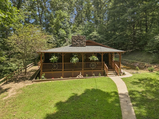 584 Mccord Hollow Rd, Hohenwald, TN 38462 - view of front facade featuring a chimney, a porch, and a front lawn