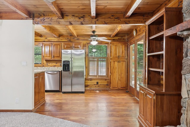 584 Mccord Hollow Rd, Hohenwald, TN 38462 - kitchen with stainless steel appliances, a wood ceiling with exposed beams, healthy amount of natural light, brown cabinets, and light wood finished floors