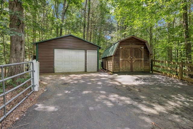 584 Mccord Hollow Rd, Hohenwald, TN 38462 - detached garage with asphalt driveway and a storage unit