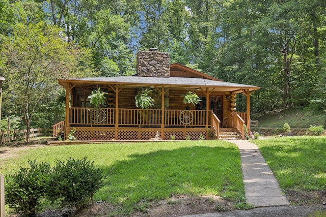 584 Mccord Hollow Rd, Hohenwald, TN 38462 - log home featuring log exterior, a porch, a front lawn, and a chimney