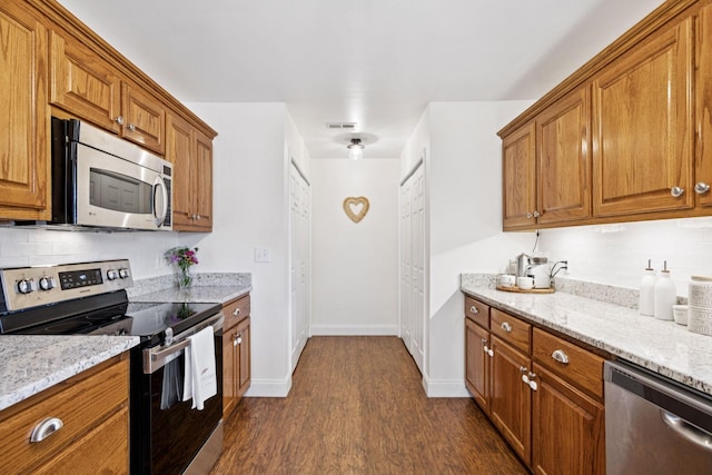 2016 Golden Ct, Spring Hill, TN 37174 - kitchen featuring appliances with stainless steel finishes, dark wood finished floors, and brown cabinets