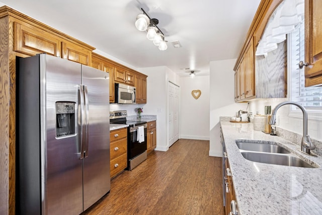 2016 Golden Ct, Spring Hill, TN 37174 - kitchen featuring stainless steel appliances, dark wood-style floors, light stone counters, and brown cabinetry