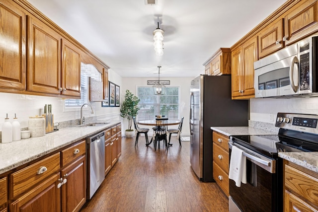 2016 Golden Ct, Spring Hill, TN 37174 - kitchen with appliances with stainless steel finishes, brown cabinets, tasteful backsplash, and dark wood-style flooring