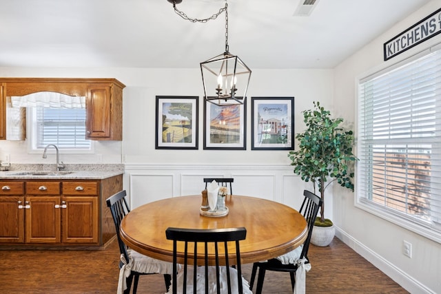 2016 Golden Ct, Spring Hill, TN 37174 - dining room with plenty of natural light, dark wood-type flooring, a chandelier, and a wainscoted wall