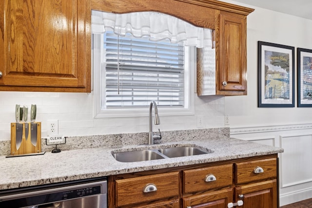 2016 Golden Ct, Spring Hill, TN 37174 - kitchen with stainless steel dishwasher, brown cabinets, and light stone counters
