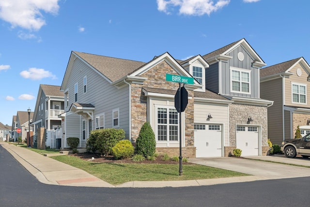 401 Birr Dr, Spring Hill, TN 37174 - view of front of house with stone siding, concrete driveway, board and batten siding, a garage, and a residential view