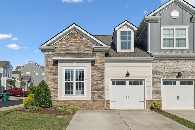 401 Birr Dr, Spring Hill, TN 37174 - view of front facade with stone siding, board and batten siding, concrete driveway, and roof with shingles