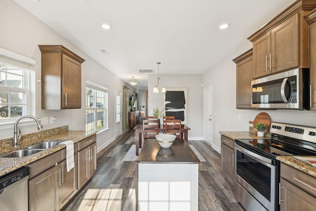 401 Birr Dr, Spring Hill, TN 37174 - kitchen with appliances with stainless steel finishes, light stone counters, dark wood-type flooring, recessed lighting, and brown cabinetry