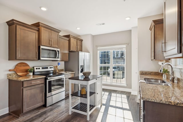 401 Birr Dr, Spring Hill, TN 37174 - kitchen featuring stainless steel appliances, light stone counters, dark wood-type flooring, and recessed lighting