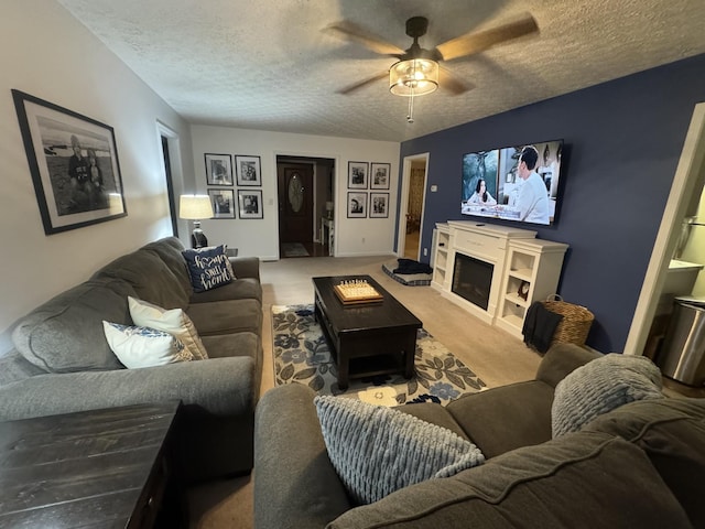 217 Red Oak Rd, Dover, TN 37058 - living room with a ceiling fan, a textured ceiling, carpet floors, and a fireplace