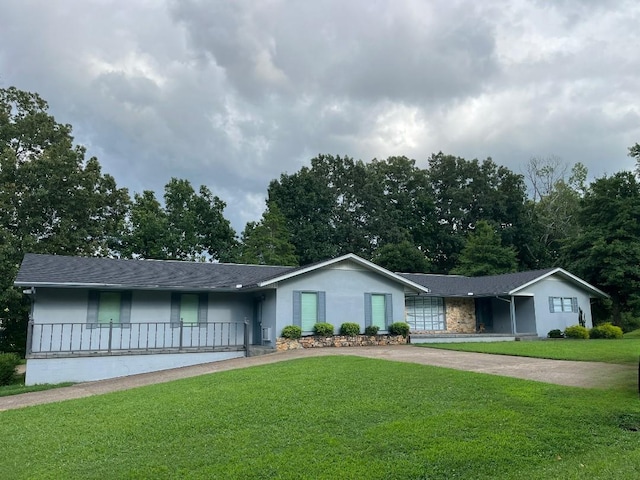 499 Pettus St, Lawrenceburg, TN 38464 - ranch-style house with a front yard, stucco siding, concrete driveway, and a shingled roof