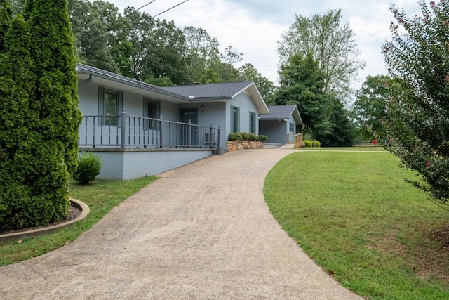 499 Pettus St, Lawrenceburg, TN 38464 - single story home with concrete driveway, a front lawn, stucco siding, covered porch, and a shingled roof