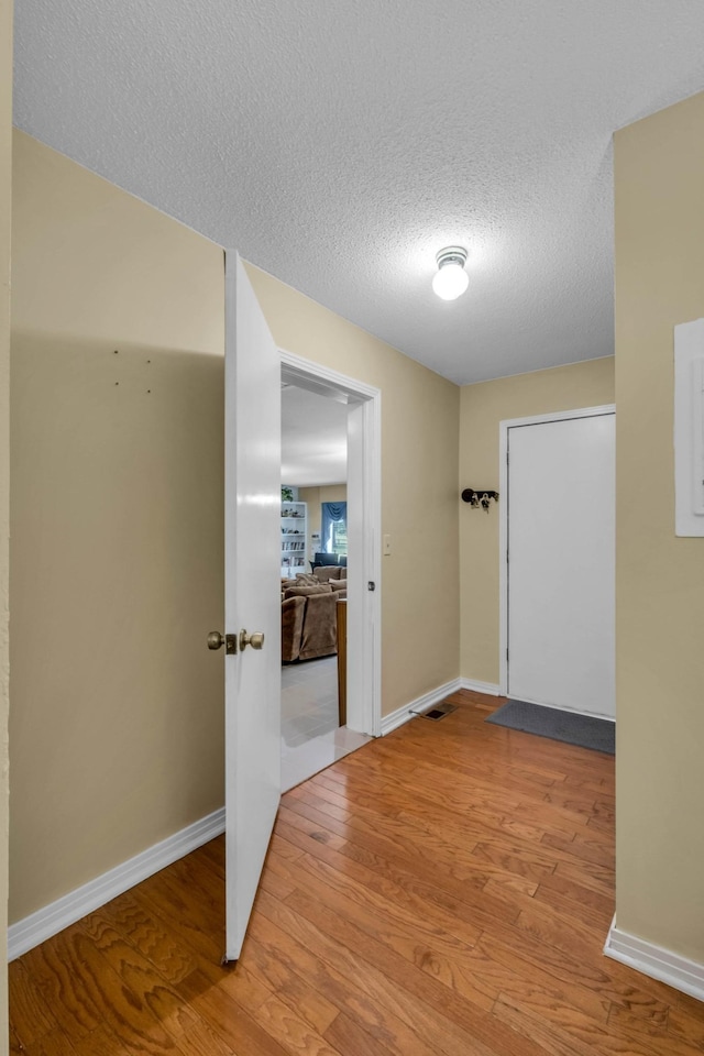 499 Pettus St, Lawrenceburg, TN 38464 - hall with wood finished floors and a textured ceiling