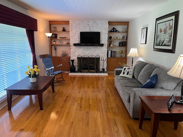 499 Pettus St, Lawrenceburg, TN 38464 - living room with light wood-style flooring, a fireplace, and built in shelves
