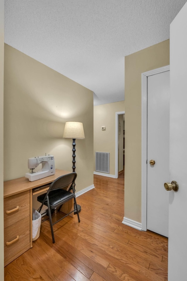 499 Pettus St, Lawrenceburg, TN 38464 - home office with light wood-style floors and a textured ceiling