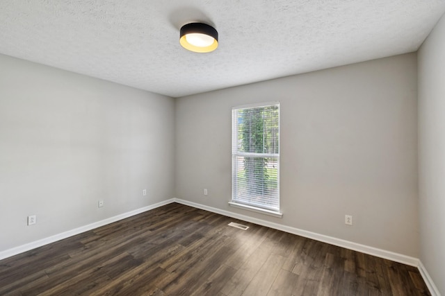 7616 Hudlow Ct, Fairview, TN 37062 - unfurnished room featuring dark wood-style flooring and a textured ceiling